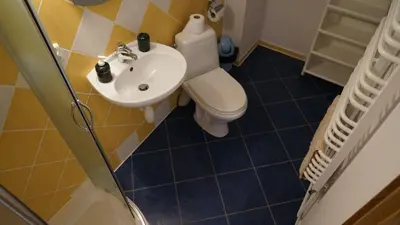 a bathroom with a toilet and a sink at DOM NA SKARPIE in Mszana Górna