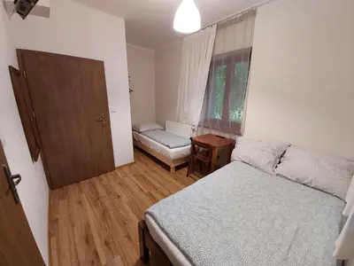 a small bedroom with a bed and a window at Eko Dworek tylko 1500m do wejścia Energylandii in Zator
