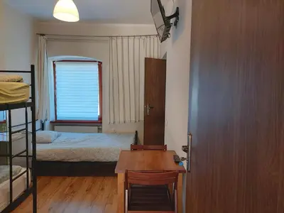 a bedroom with a bed and a desk with a table at Eko Dworek tylko 1500m do wejścia Energylandii in Zator