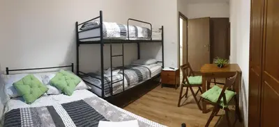 a bedroom with two bunk beds and a table at Eko Dworek tylko 1500m do wejścia Energylandii in Zator