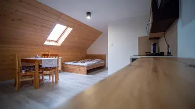 a room with a table and a bed in a room at U Jędrusia in Zubrzyca Górna