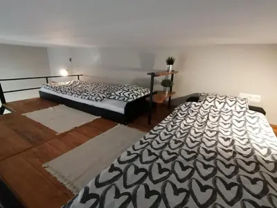 two beds sitting in a room with at Studio Krakow old town apartment in Kraków