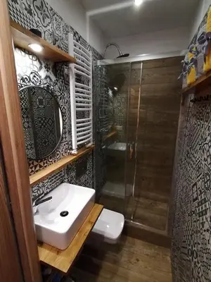 a bathroom with a sink and a shower at Studio Krakow old town apartment in Kraków