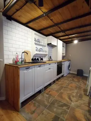 a large kitchen with white cabinets and a sink at Studio Krakow old town apartment in Kraków