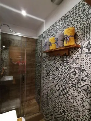 a bathroom with a shower and a glass shower stall at Studio Krakow old town apartment in Kraków
