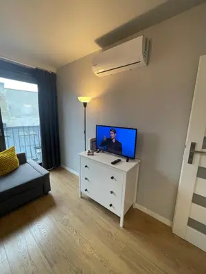 a living room with a tv on a dresser at Sunflower Apartment Old Town in Kraków