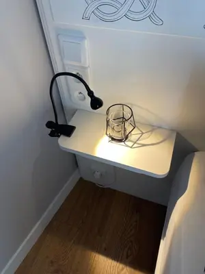 a lamp on a desk next to a bed at Sunflower Apartment Old Town in Kraków