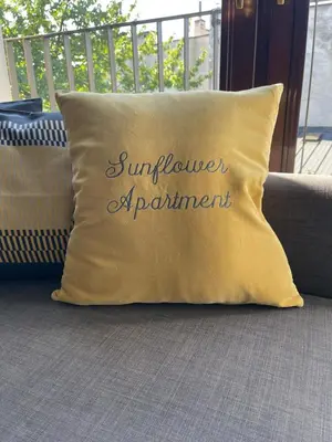 a pillow that says sunflower of parliament on a couch at Sunflower Apartment Old Town in Kraków