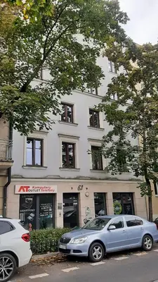 two cars parked in front of a building at Sunflower Apartment Old Town in Kraków