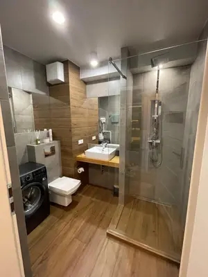 a bathroom with a toilet and a sink and a shower at Sunflower Apartment Old Town in Kraków