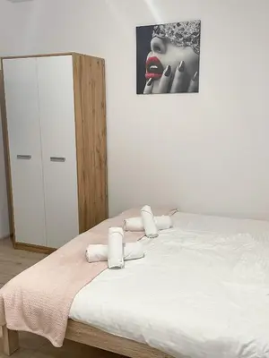 a bedroom with a bed and a picture of a woman with red lipstick at Land House in Zator
