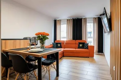a living room with a table and a couch at Apartament Glamour Kraków in Kraków