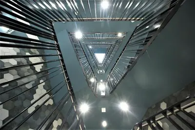 a view of the ceiling of a building with lights at Apartament Glamour Kraków in Kraków