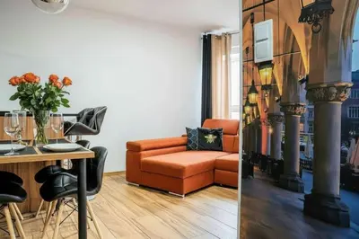 a living room with a couch and a table at Apartament Glamour Kraków in Kraków