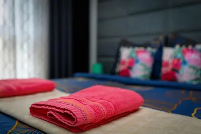 two red towels sitting on top of a bed at Apartament Glamour Kraków in Kraków