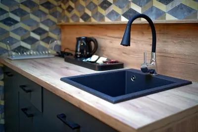 a kitchen counter with a sink in a kitchen at Apartments ALKANTARA in Chrzanów