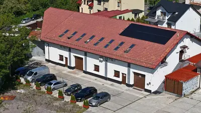 an overhead view of a building with cars parked in a parking lot at Apartments ALKANTARA in Chrzanów