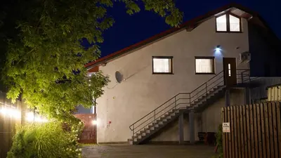 a building with stairs on the side of it at night at Apartments ALKANTARA in Chrzanów