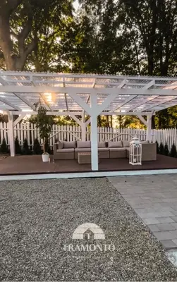 a white pergola with couches under it at Tramonto Apartments Zator Przeciszów in Zator