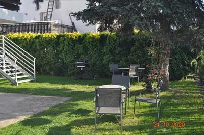 a group of chairs and a table in the grass at Noclegi u Tadka in Zator