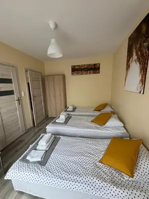 two twin beds in a room withthritisthritisthritisthritisthritisthritisthritisthritisthritis at Noclegi u Tadka in Zator