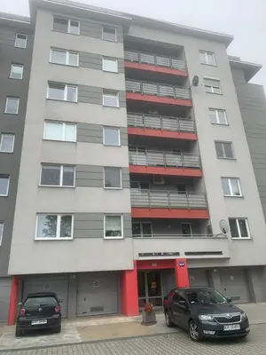 two cars parked in front of a building at Apartament 6 piętro in Kraków