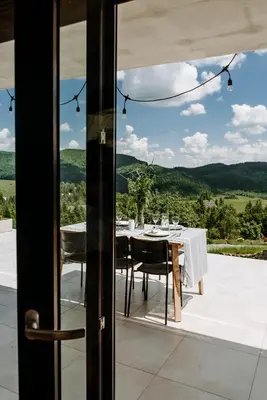 a dining room with a table and a view at Gorczańskie Zacisze in Lubomierz
