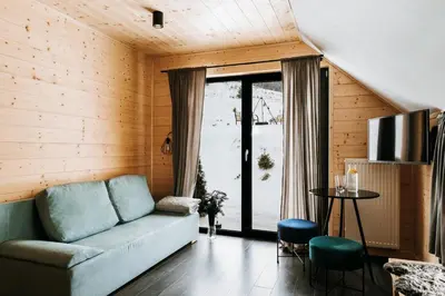 a living room with a couch and a table at Gorczańskie Zacisze in Lubomierz