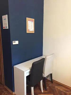 a desk with a chair and a blue wall at Lilia in Kraków