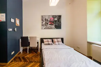 a bedroom with a bed and a red double decker bus at Lilia in Kraków
