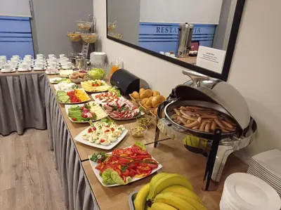 a buffet line with many different plates of food at Hotel Olimpijski in Oświęcim