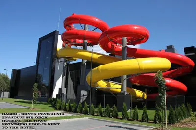 a large water slide in front of a building at Hotel Olimpijski in Oświęcim