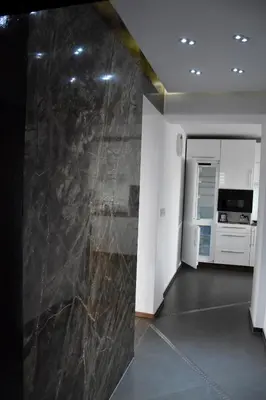 a living room with a large marble wall at Apartament Night Premium Krakow in Kraków