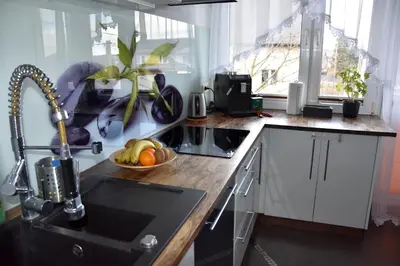 a kitchen with a sink and a bowl of fruit at Apartament Night Premium Krakow in Kraków