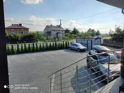 a parking lot with a car parked in it at Krollhouse Pokoje gościnne in Wolbrom