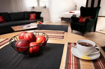 a bowl of apples and a cup of coffee on a table at Solny Domek Salt House in Wieliczka