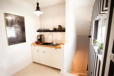 a small kitchen with a sink and a counter at Solny Domek Salt House in Wieliczka