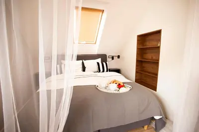 a bedroom with a bed with a plate of fruit on it at Solny Domek Salt House in Wieliczka