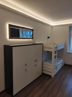 a room with a desk and a bunk bed at Greg&Tom Hostel in Kraków