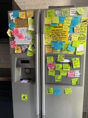 a refrigerator with lots of notes on it at Greg&Tom Hostel in Kraków