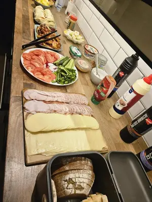 a table with many different types of food on it at Greg&Tom Hostel in Kraków