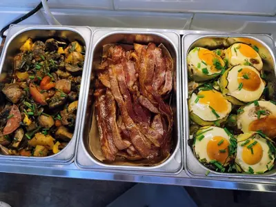 three plastic containers of food with eggs and meat at Greg&Tom Hostel in Kraków