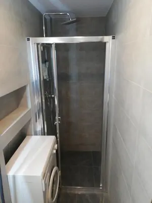 a shower with a glass door in a bathroom at Andrychów Apartment in Andrychów
