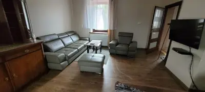a living room with a couch and a table at Andrychów Apartment in Andrychów