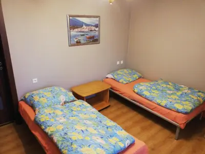 a room with two beds and a table in it at Andrychów Apartment in Andrychów