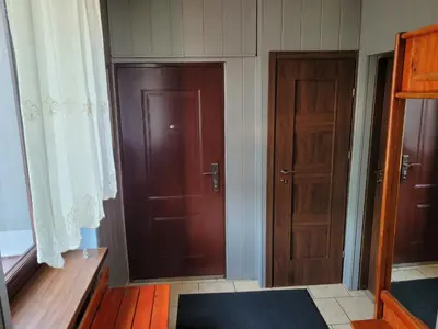 a room with two wooden doors and a rug at Andrychów Apartment in Andrychów