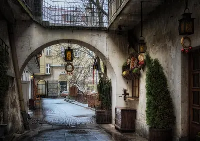 an alley with an archway in a building at Golden Queen Apartments Jewish District in Kraków