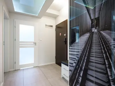 a staircase in a hallway with a glass wall at Golden Queen Apartments Jewish District in Kraków