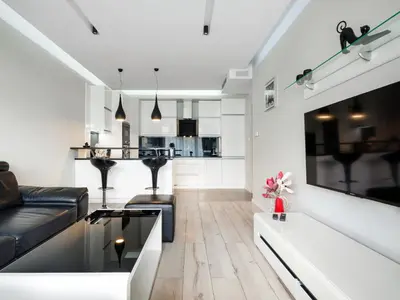 a living room with a couch and a kitchen at Golden Queen Apartments Jewish District in Kraków