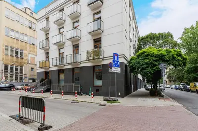 a building on a street with cones in front of it at Studios Lubelska Kraków by Noclegi Renters in Kraków